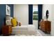 Inviting bedroom with blue accent wall, decorative rug, and natural light from the window at 31718 Griffin Sands Ln, San Antonio, FL 33576