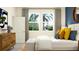 Well-lit main bedroom with a comfortable bed, stylish furniture, and a serene atmosphere at 31718 Griffin Sands Ln, San Antonio, FL 33576