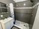Modern bathroom with stand up shower, vanity, and decorative mirror at 3515 E 8Th Ave, Tampa, FL 33605