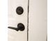 Modern black door lever and lock hardware on a white painted door at 3515 E 8Th Ave, Tampa, FL 33605