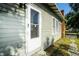 Side view of a home highlighting a white wood door and window at 3515 E 8Th Ave, Tampa, FL 33605