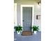 Stylish front door with a welcome mat and potted plants, creating a warm entrance at 3515 E 8Th Ave, Tampa, FL 33605