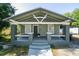 Charming bungalow with a covered front porch, gray siding, and updated gray foundation at 3515 E 8Th Ave, Tampa, FL 33605