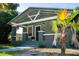 Cozy home featuring a covered porch and decorative palm tree in the front yard at 3515 E 8Th Ave, Tampa, FL 33605