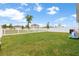 Spacious backyard featuring a large, well-maintained lawn and a white picket fence at 35519 Bellington Blvd, Zephyrhills, FL 33541
