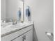 A well-lit bathroom featuring a vanity with a white marble countertop and a sink at 35519 Bellington Blvd, Zephyrhills, FL 33541