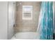 Cozy bathroom featuring a shower with a window and a unicorn-themed shower curtain at 35519 Bellington Blvd, Zephyrhills, FL 33541