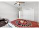 Bright bedroom featuring neutral walls, ceiling fan and a comfortable bedspread at 35519 Bellington Blvd, Zephyrhills, FL 33541