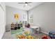 Playful bedroom featuring colorful decor, natural lighting, and ample storage space at 35519 Bellington Blvd, Zephyrhills, FL 33541