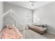 This bedroom features a play bed, large window and neutral decor at 35519 Bellington Blvd, Zephyrhills, FL 33541