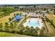 An aerial view of the community amenities showing the pool, clubhouse, and playground at 35519 Bellington Blvd, Zephyrhills, FL 33541