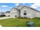 Charming single-story home with a gray exterior, a two-car garage, and a well-manicured lawn at 35519 Bellington Blvd, Zephyrhills, FL 33541