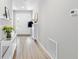 Inviting foyer with light wood floors, white walls, and decorative console table at 35519 Bellington Blvd, Zephyrhills, FL 33541
