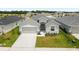 Charming single-story home featuring a well-manicured lawn and an attached two-car garage at 35519 Bellington Blvd, Zephyrhills, FL 33541
