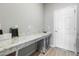 Well-organized laundry room featuring a countertop, storage baskets and bright lighting at 35519 Bellington Blvd, Zephyrhills, FL 33541