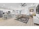 Open-concept living room, kitchen, and dining area, with modern decor and plenty of natural light at 35519 Bellington Blvd, Zephyrhills, FL 33541