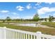 Scenic pond view with surrounding trees, captured from the fenced-in backyard at 35519 Bellington Blvd, Zephyrhills, FL 33541