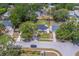 Aerial shot of a home in a quiet neighborhood with mature trees and well-maintained lawns at 3852 Berkshire Ct, Palm Harbor, FL 34684