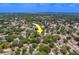The house is in a neighborhood with mature trees and near a highway and lake at 3852 Berkshire Ct, Palm Harbor, FL 34684