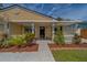 Charming front entrance with a walkway, manicured landscaping, and a cheerful yellow exterior at 3852 Berkshire Ct, Palm Harbor, FL 34684