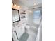 Bright bathroom with a shower-tub combo, updated vanity, and modern lighting fixtures at 4715 W Chapin Ave, Tampa, FL 33611
