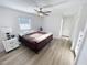 Cozy bedroom featuring light wood floors, a ceiling fan and ample natural light at 4715 W Chapin Ave, Tampa, FL 33611