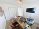 Bright room with wood-look flooring, closet, large desk with computer, and wall-mounted tv at 4715 W Chapin Ave, Tampa, FL 33611