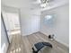Bright bedroom features a ceiling fan, wood-look flooring, and a double-door closet at 4715 W Chapin Ave, Tampa, FL 33611