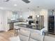 Bright, open kitchen with stainless steel appliances, an island with seating, and white cabinets at 4715 W Chapin Ave, Tampa, FL 33611