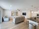 Inviting living room with a modern ceiling fan, adjacent to a kitchen with barstool seating at 4715 W Chapin Ave, Tampa, FL 33611