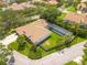 Overhead view of a beautiful home featuring an oversized screened-in pool, tile roof, and verdant landscaping at 4766 Royal Palm Ne Cir, St Petersburg, FL 33703