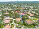 An aerial shot shows many houses surrounded by beautiful green trees and swimming pools at 4766 Royal Palm Ne Cir, St Petersburg, FL 33703