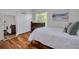 Bright bedroom with hardwood floors, closet with a basketball hoop, and a comfortable bed at 4766 Royal Palm Ne Cir, St Petersburg, FL 33703
