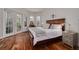 Cozy bedroom with hardwood floors, French doors, and windows for ample natural light and a closet at 4766 Royal Palm Ne Cir, St Petersburg, FL 33703