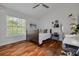 Cozy bedroom features hardwood floors, a comfortable bed, and modern desk space at 4766 Royal Palm Ne Cir, St Petersburg, FL 33703