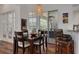 Dining room with wood table next to screened patio with furniture and garden view at 4766 Royal Palm Ne Cir, St Petersburg, FL 33703