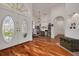 Elegant foyer showcasing hardwood floors, a large arched window above the front door, and high ceilings at 4766 Royal Palm Ne Cir, St Petersburg, FL 33703