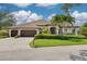 Inviting single-story home showcasing a tile roof, an attached two-car garage, and meticulously maintained landscaping at 4766 Royal Palm Ne Cir, St Petersburg, FL 33703