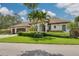 Charming single-Gathering home featuring a tile roof, well-manicured lawn and lush landscaping at 4766 Royal Palm Ne Cir, St Petersburg, FL 33703