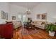 Bright living room featuring hardwood floors, neutral-colored sofas, and a decorative chandelier at 4766 Royal Palm Ne Cir, St Petersburg, FL 33703