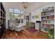 Well-lit office featuring a large arched window, a cozy armchair with an ottoman, and hardwood floors at 4766 Royal Palm Ne Cir, St Petersburg, FL 33703