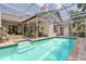 Beautiful blue pool featuring steps leading from the patio and surrounded by a screened-in enclosure at 4766 Royal Palm Ne Cir, St Petersburg, FL 33703