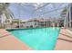 Inviting in-ground pool with screened-in enclosure, creating a backyard oasis perfect for relaxing at 4766 Royal Palm Ne Cir, St Petersburg, FL 33703
