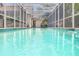 Inviting in-ground pool with screened-in enclosure, creating a private backyard oasis at 4766 Royal Palm Ne Cir, St Petersburg, FL 33703