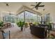 Screened patio features outdoor seating, ceiling fans, and views of pool and landscaping at 4766 Royal Palm Ne Cir, St Petersburg, FL 33703