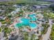 Breathtaking aerial view of a resort-style community featuring a large pool, lush landscaping, and inviting recreational spaces at 4946 Mill Pond Rd # 3180, Wesley Chapel, FL 33543
