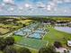 Aerial view of tennis courts and athletic field in a beautiful community setting at 4946 Mill Pond Rd # 3180, Wesley Chapel, FL 33543