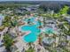 An aerial view shows a large resort pool with lush landscaping and amenities at 4946 Mill Pond Rd # 3180, Wesley Chapel, FL 33543