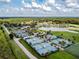 Aerial view of tennis courts, lake, trees, and athletic field at 4946 Mill Pond Rd # 3180, Wesley Chapel, FL 33543