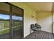 Condo balcony offers seating and golf course views through the sliding glass doors at 4946 Mill Pond Rd # 3180, Wesley Chapel, FL 33543